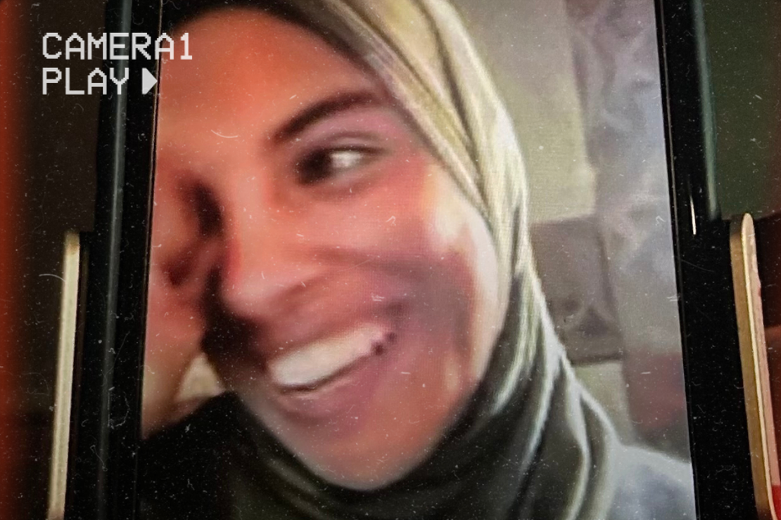 Fatma Hassouna smiling in a green headscarf.