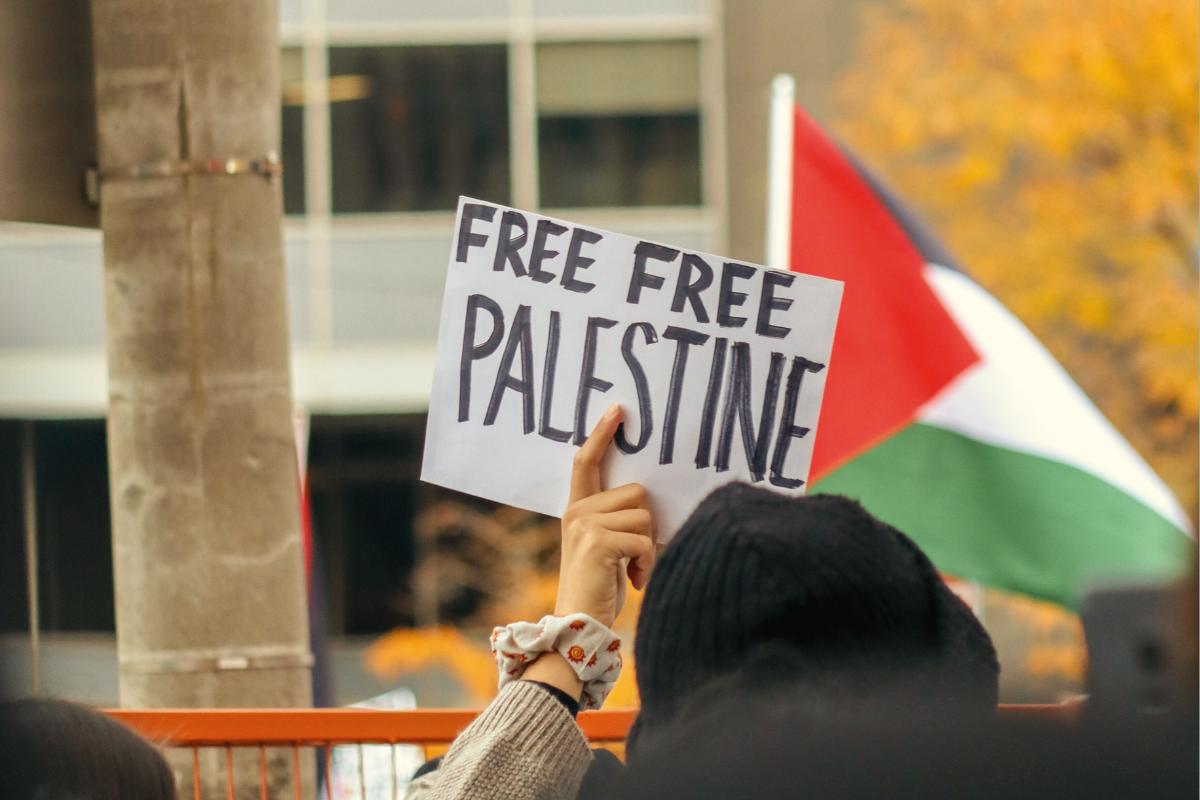 Poster up in the air saying "Free Free Palestine"