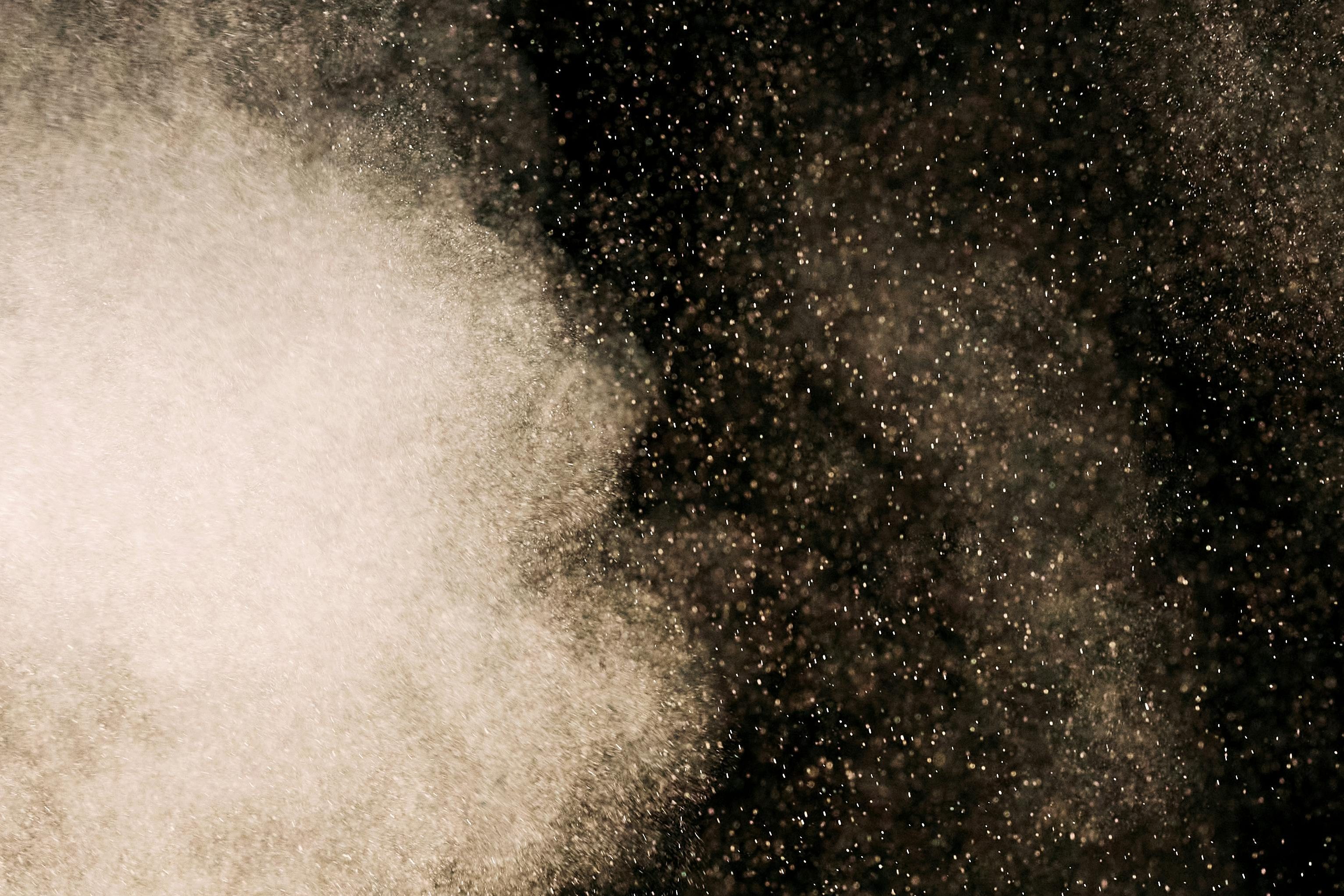 Particles of light beaming in darkness.